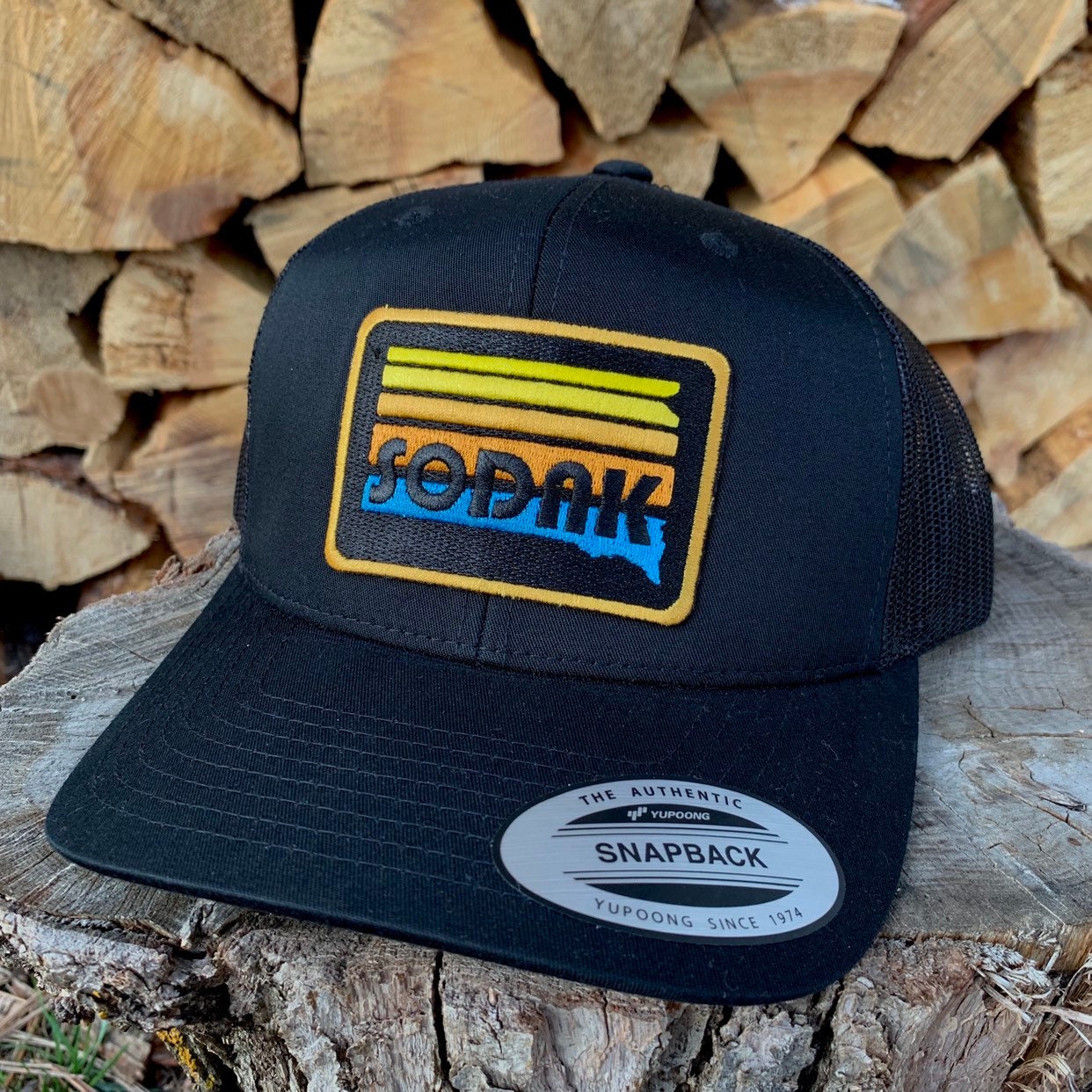 SoDak Sunset Black Trucker Cap by Oh Geez! Design
