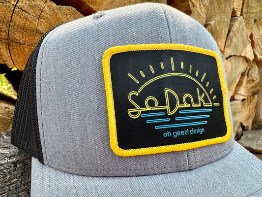 SoDak Neon Sun Trucker Cap by Oh Geez! Design