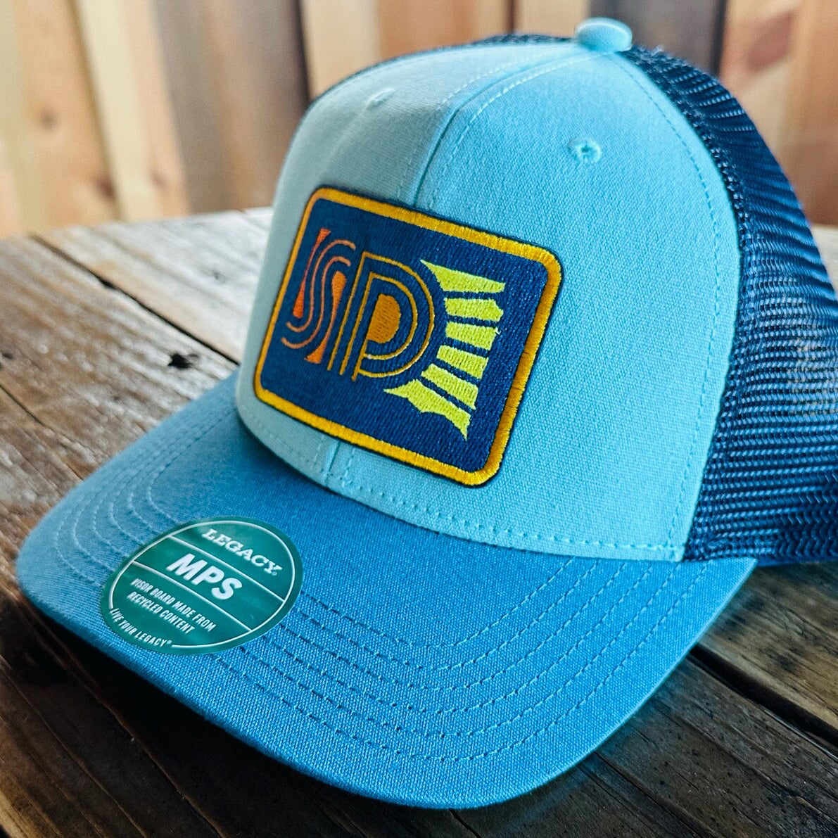 Blue trucker hat with South Dakota logo patch