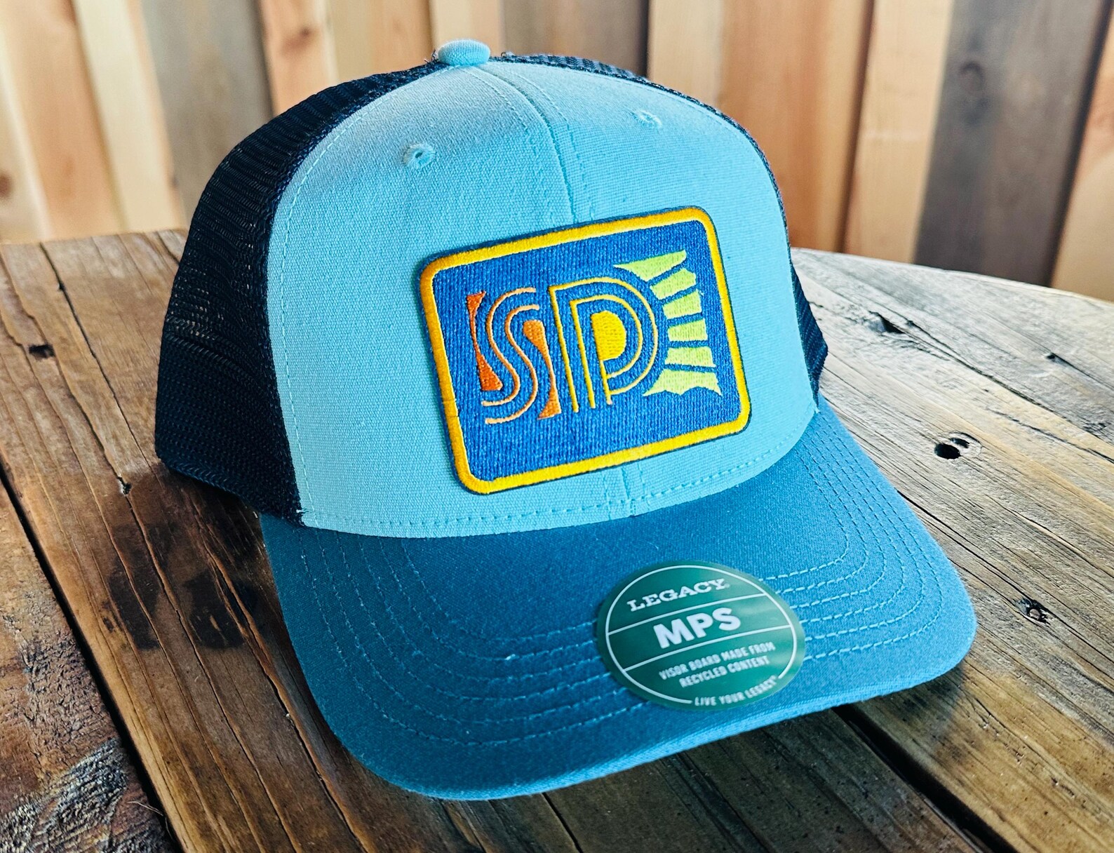 Blue trucker hat with South Dakota logo patch